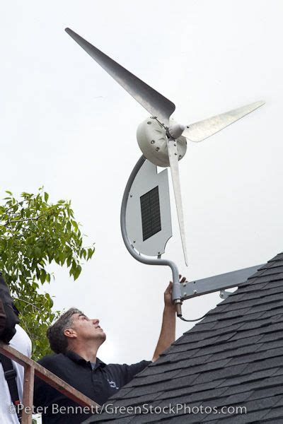 Installation of a residential wind turbine is filmed for an episode of the DIY network show ...