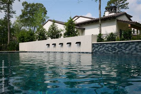 THE WOODLANDS, TEXAS - MAY 5th 2023: an outdoor pool and spa with water features on a hot sunny ...