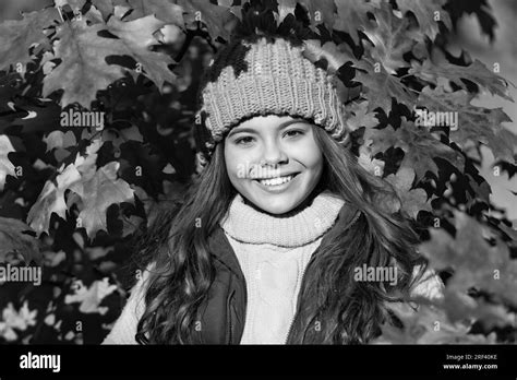 positive child in hat standing at autumn leaves Stock Photo - Alamy