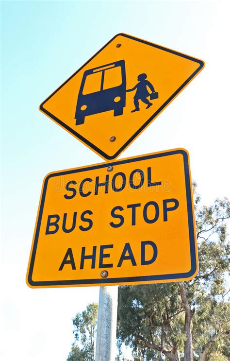 Yellow And Black School Bus Stop Ahead Sign And Blue Sky Stock Photo ...