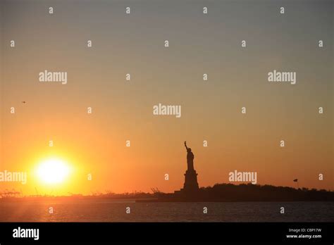 Sunset with Statue of Liberty Stock Photo - Alamy