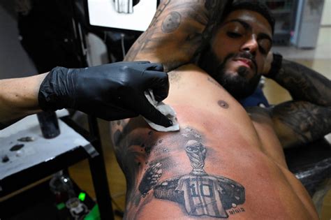 Tattoo artists in Argentina swamped by demand from fans eager to pay tribute to Lionel Messi ...