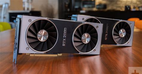 two video cards sitting on top of a wooden table