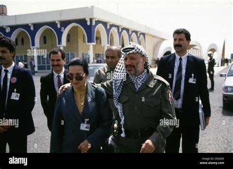 palestinian president yasser arafat walks with his sister during the ...