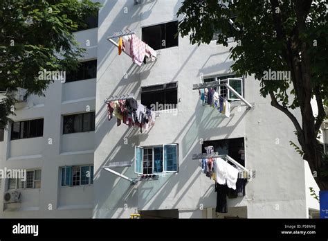 drying laundry hanging from poles at HDB flats in Singapore Stock Photo - Alamy