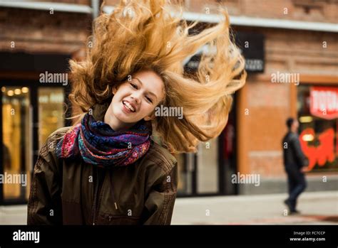 Caucasian woman tossing hair outdoors Stock Photo - Alamy