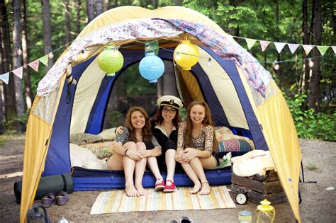 Girls relaxing in camping tent stock photo