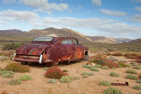 An Old Rusted Car Lies Derelict In Photograph by Anthony Grote - Fine Art America