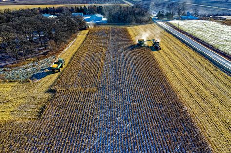 Farm Tractor Harvesting on Field · Free Stock Photo