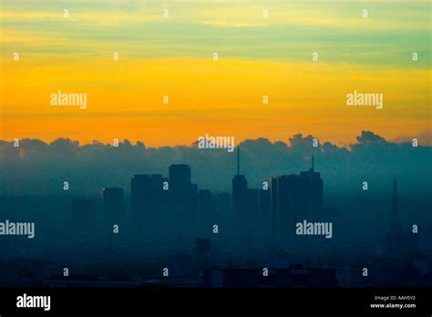 The skyline of Makati City Manila at sunrise shrouded in mist and fog ...