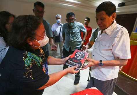 Gifting Duterte with Pat Evangelista’s “Some People Need Killing” book