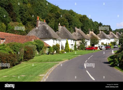 The picturesque thatched roof cottages of Milton Abbas Village Dorset ...