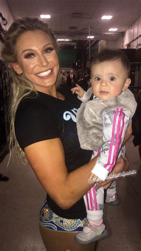 WWE Superstar Charlotte Flair (Ashley Fliehr) holding Monroe Sky ...