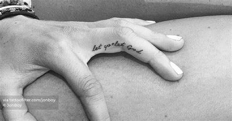 Tattoo that says "let go let God" handwritten on the