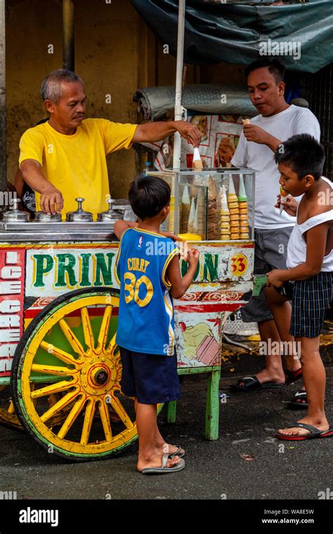 Local People Buying Ice Creams From A Mobile Ice Cream Cart In Intramuros, Manila, The ...