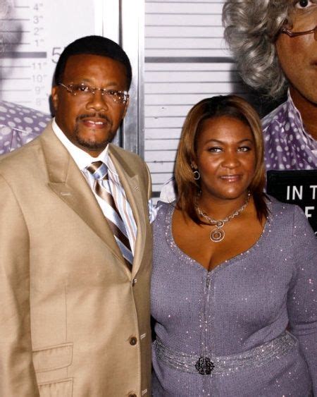 a man and woman standing next to each other in front of a mugshot poster