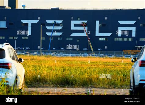 "Tesla" logo is put up on the outside wall of Tesla Gigafactory under construction at the Lin ...