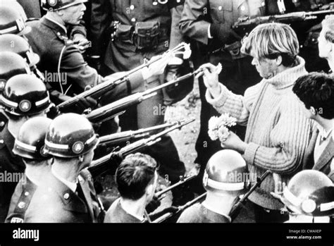 Vietnam War protestor puts flowers into the barrels of soldiers' rifles, 1967. Courtesy: CSU ...