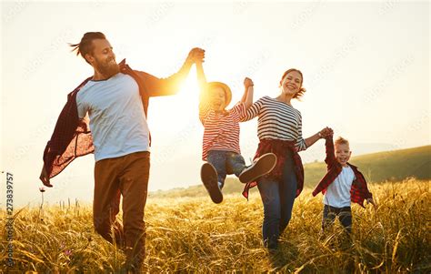 Happy family: mother, father, children son and daughter on sunset. Stock Photo | Adobe Stock