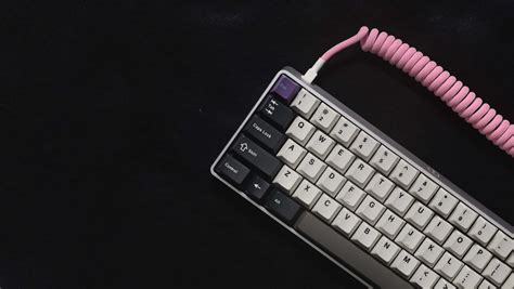 Download A Pink Keyboard With A Pink Cord | Wallpapers.com