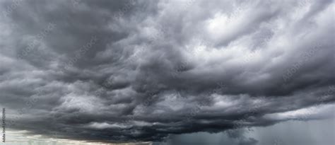 The dark sky with heavy clouds converging and a violent storm before the rain.Bad or moody ...