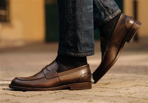 Man wearing brown leather penny loafers with dark brown socks and raw ...