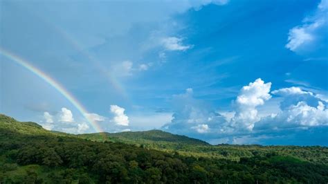 Premium Photo | Rainbow on sky in the mountains panorama of flying in a nature rainbow in the ...