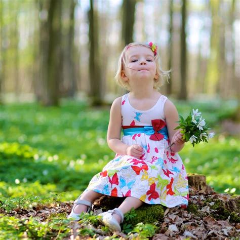 Little girl playing in beautiful forest Stock Photo by ©CroMary 113827368