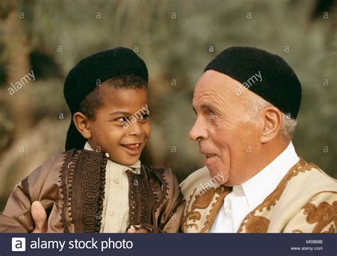 Libya. Ghadames oasis. Sahara desert. Local Berber boy and man dressed for a family wedding ...