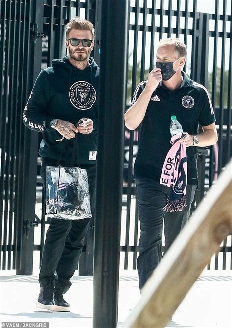 David Beckham is cool in a hoodie and sunglasses as he arrives at the ...