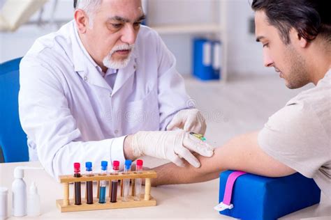 The Young Handsome Man during Blood Test Sampling Procedure Stock Image ...