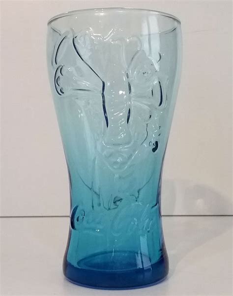 a blue glass vase sitting on top of a table