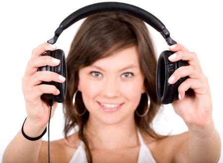 music for your ears - girl holding headphones in front of the camera over a white background ...