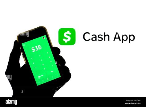 In this photo illustration a Cash App seen displayed on a smartphone with the Cash App logo in ...