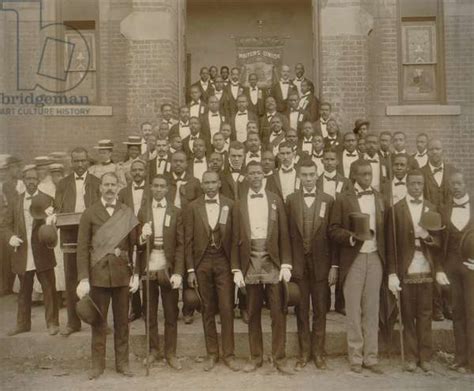 Image of Formally dressed African American men pose with derbies and top