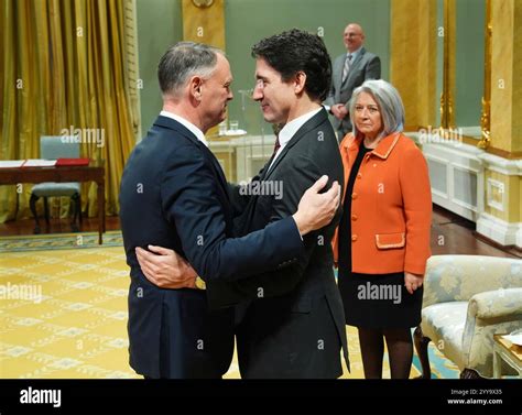 Public Safety Minister David McGuinty and Prime Minister Justin Trudeau hug as Gov. Gen. Mary ...