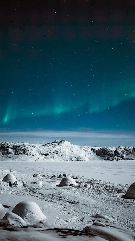 Northern lights over snowy Greenland Photograph by Murellos Design - Fine Art America