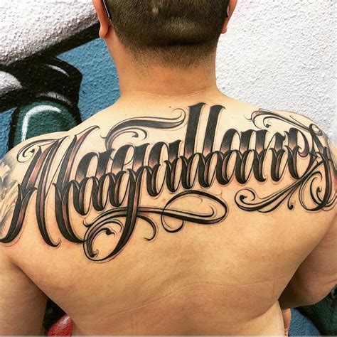 the back of a man's upper and lower half - sleeved tattoo that reads,