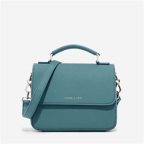 CHARLES & KEITH - Bags. Teal top handle sling bag featuring front flap ...