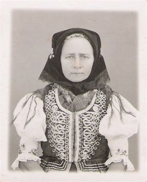 an old black and white photo of a woman in renaissance clothing with a hood over her head