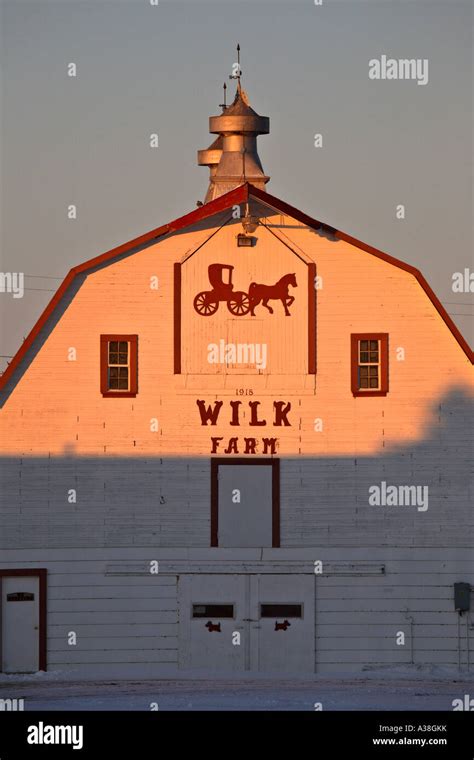 restored white barn half lit by sun Stock Photo - Alamy