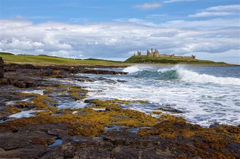 Premium Photo | View of dunstanburgh castle at craster northumberland