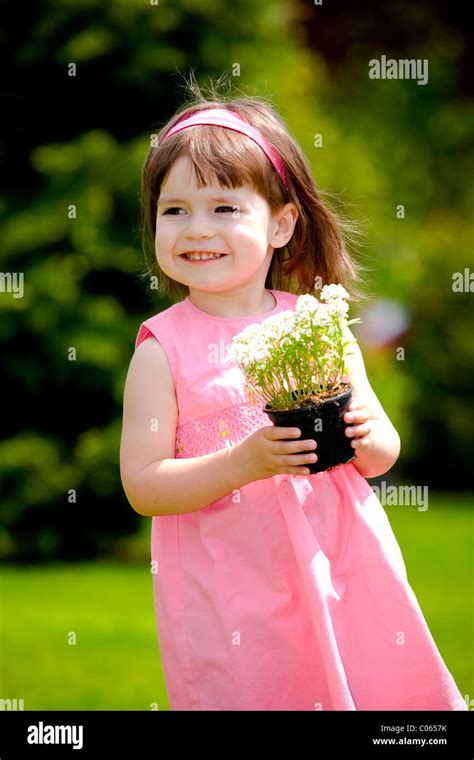 Little girl with flower pot Stock Photo - Alamy