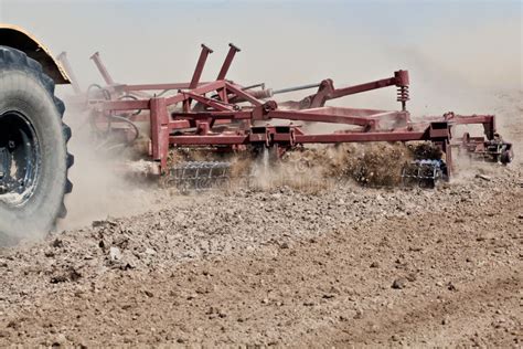 Harrowing a field stock image. Image of combine, golden - 21007033