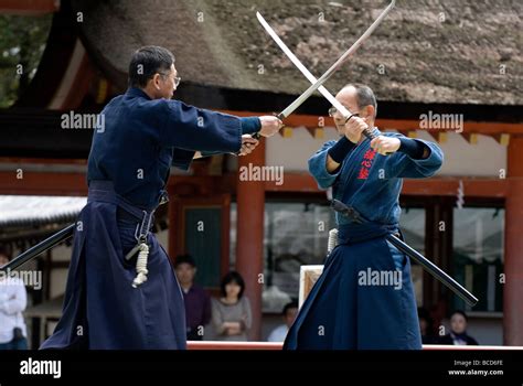 Two men engaged in a sword fight using real samurai swords during a ...