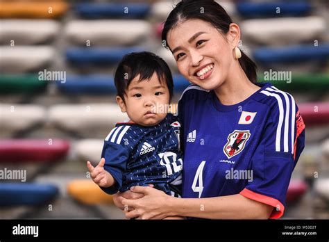 Japanese football fans wave their national flags to show support for ...