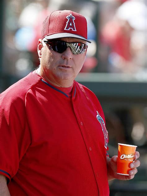 Los Angeles Angels' Mike Scioscia pauses in the dugout as he watches ...