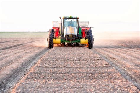 A Tractor and Planting Implement Planting Potatoes in an Idaho Field ...