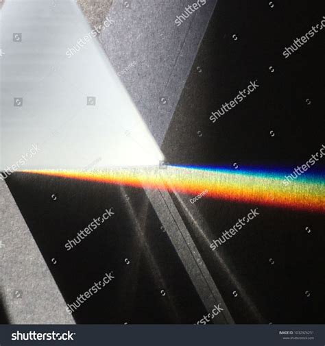 Sunlight through prism on dark background scattering rainbow spectrum, shadow and light ...