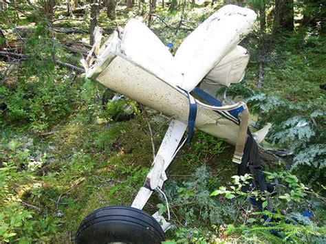 Main landing gear attached to a section of lower fuselage and the 2 cabin seats of Cessna 150 ...